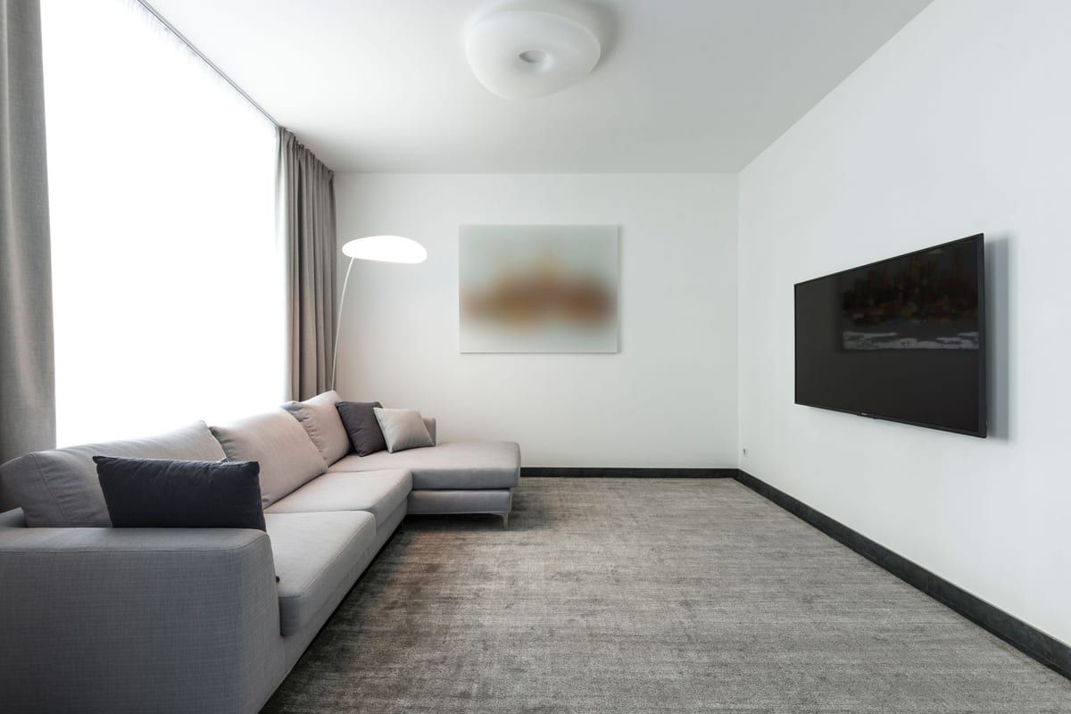 The room re-carpeted in a soft, modern grey