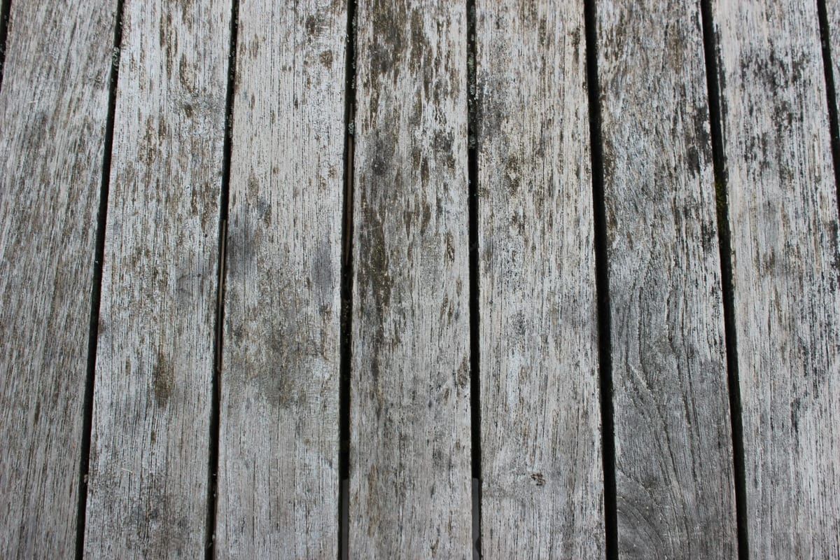 Grey, weathered timber boards before restoration